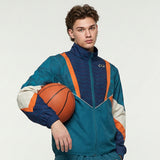 young man wearing a colorful C2C Sport tracktop with collar, featuring a woven microfibre exterior and soft cotton jersey lining,